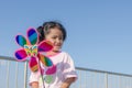 Asian little girl with wind turbine toy in hands Royalty Free Stock Photo