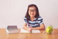 Asian little girl writeing a book on table Royalty Free Stock Photo