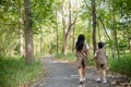 Asian little girls explore nature through magnifying glasses and binoculars in the park. Education, field trips, research, and Royalty Free Stock Photo