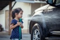 asian little girls helping parent washing a car Royalty Free Stock Photo