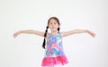 Asian little kid girl with pigtail hair standing and open wide arms with looking camera isolated on white Royalty Free Stock Photo