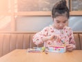 Asian little kid girl play the edible toy