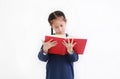 Asian little kid girl reading a book isolated on white background. Education concept Royalty Free Stock Photo