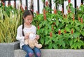 Asian little kid girl wearing mask for teddy bear doll to protect coronavirus covid-19 and air pollution in bangkok city, thailand Royalty Free Stock Photo