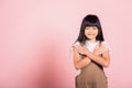 Asian little kid 10 years old doing grateful gesture and closed eyes Royalty Free Stock Photo