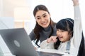 Asian little young girl kid learning online class at home with mother. Preschool child use laptop computer do homework, homeschool