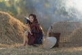 Asian local beautiful woman listening radio on straw