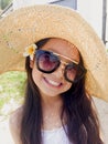 Asian long black hair girl is wearing black sunglasses, straw ha Royalty Free Stock Photo