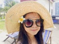 Asian long black hair girl is wearing black sunglasses, straw ha Royalty Free Stock Photo