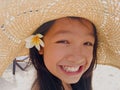 Asian long black hair girl is wearing straw hat and white flower Royalty Free Stock Photo