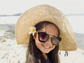 Asian long black hair girl is wearing black sunglasses, straw ha Royalty Free Stock Photo