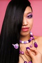 Asian with long black hair in lingerie and with purple beads. Royalty Free Stock Photo