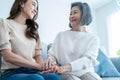 Asian lovely family, young daughter hugging and sit with older mother. Attractive woman granddaughter visit senior elder mature Royalty Free Stock Photo