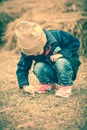 Asian lovely girl in her winter warm clothing playing at farm. O Royalty Free Stock Photo