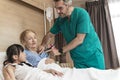 Asian lovely young girl visit and encourage grandmother when The doctor examines a elder patient on patient bed in hospital Royalty Free Stock Photo