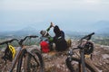 Asian lover woman and man Travel Nature. Travel relax ride a bike Wilderness in the wild. Sit on a rocky cliff