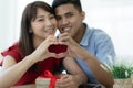 Asian lovers couple doing love sign with hand together