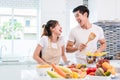 Asian lovers or couples cooking so funny together in kitchen wit Royalty Free Stock Photo