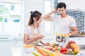 Asian lovers or couples cooking so funny together in kitchen wit Royalty Free Stock Photo