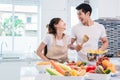 Asian lovers or couples cooking so funny together in kitchen wit Royalty Free Stock Photo