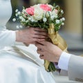 Asian lovers' hands holding vintage flower