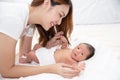 Asian loving mom carying of her newborn baby at home. Happy mum holding sleeping infant child on hands. Mother hugging her little Royalty Free Stock Photo