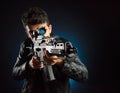 Asian mafia guy in black jacket and automatic rifle in hand