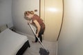 Asian maid Cleaning Service with Mop cleaning floor on a bedroom. Royalty Free Stock Photo