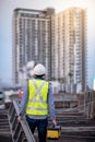 Worker man carrying aluminium ladder and tool box Royalty Free Stock Photo