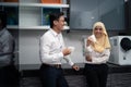 Asian malay couple having a coffee in pantry office Royalty Free Stock Photo
