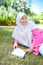 Asian Malay Muslim woman reading
