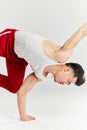 Asian male breakdancer dancing on white background, doing shoulder freeze stance Royalty Free Stock Photo