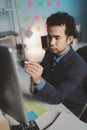 Asian male businessman working in the room. Startup company employees are working in the office at night, overtime, busy work, Royalty Free Stock Photo