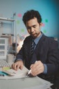 Asian male businessman working in the room. Startup company employees are working in the office at night, overtime, busy work, Royalty Free Stock Photo