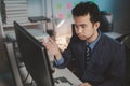 Asian male businessman working in the room. Startup company employees are working in the office at night, overtime, busy work, Royalty Free Stock Photo