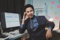 Asian male businessman working in the room. Startup company employees are working in the office at night, overtime, busy work, Royalty Free Stock Photo