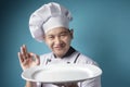 Asian Male Chef Shows Empty White Plate, Presenting Something, Copy Space Royalty Free Stock Photo