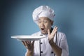 Asian Male Chef Shows Empty White Plate, Presenting Something, Copy Space Royalty Free Stock Photo