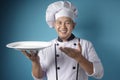 Asian Male Chef Shows Empty White Plate, Presenting Something, Copy Space Royalty Free Stock Photo