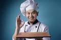 Asian Male Chef Shows Empty Wooden Plate, Presenting Something, Copy Space Royalty Free Stock Photo