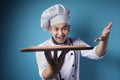 Asian Male Chef Shows Empty Wooden Plate, Presenting Something, Copy Space Royalty Free Stock Photo