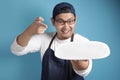 Asian Male Chef or Waiter Shows Empty White Plate, Presenting Something, Copy Space Royalty Free Stock Photo