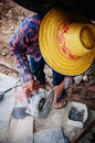Asian male construction labour use cutting wheel to cut stone tile with no safety equipment