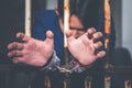 Asian male criminals was arrested and handcuffed in a dirty cage Royalty Free Stock Photo