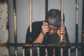 Asian male criminals was arrested and handcuffed  in a dirty cage Royalty Free Stock Photo