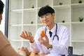 Asian male doctor explaining medicine dosage to patient. Medicine, healthcare and people concept. Royalty Free Stock Photo