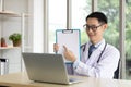 Male doctor holding medical clipboard paper, empty space for writing text