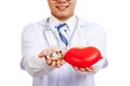 Asian male doctor with red heart and pills Royalty Free Stock Photo