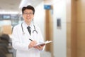 Asian male doctor smiling in the background of the hospital Royalty Free Stock Photo