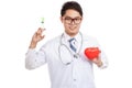 Asian male doctor with syringe and red heart Royalty Free Stock Photo